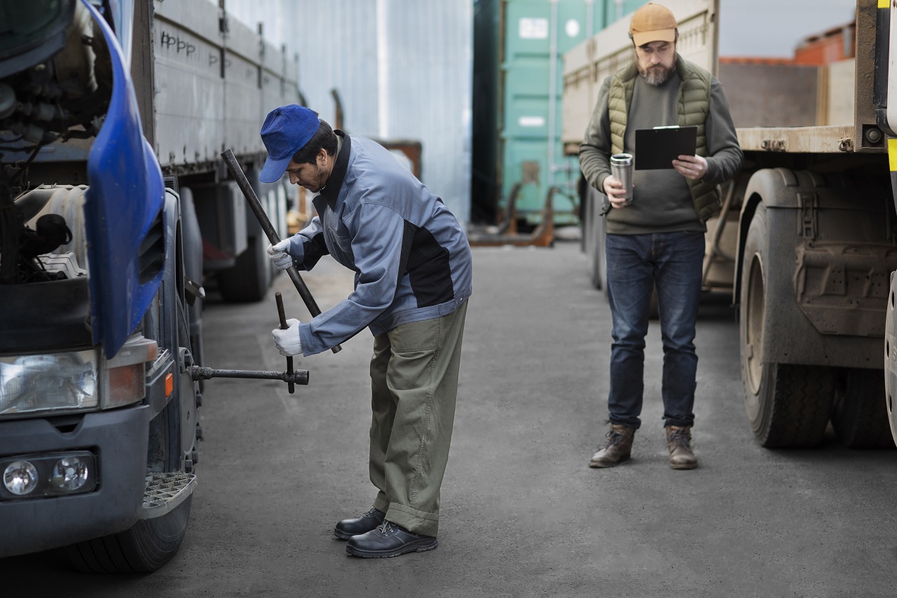 fleet mechanic checking on trucks